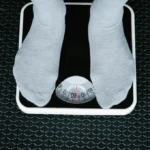 person standing on a scale for a blog about how to lose weight