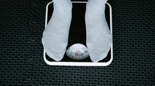 person standing on a scale for a blog about how to lose weight