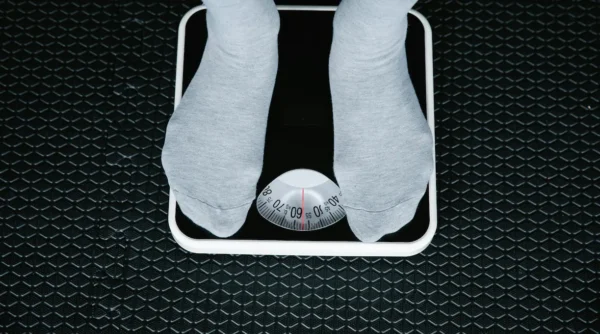 person standing on a scale for a blog about how to lose weight