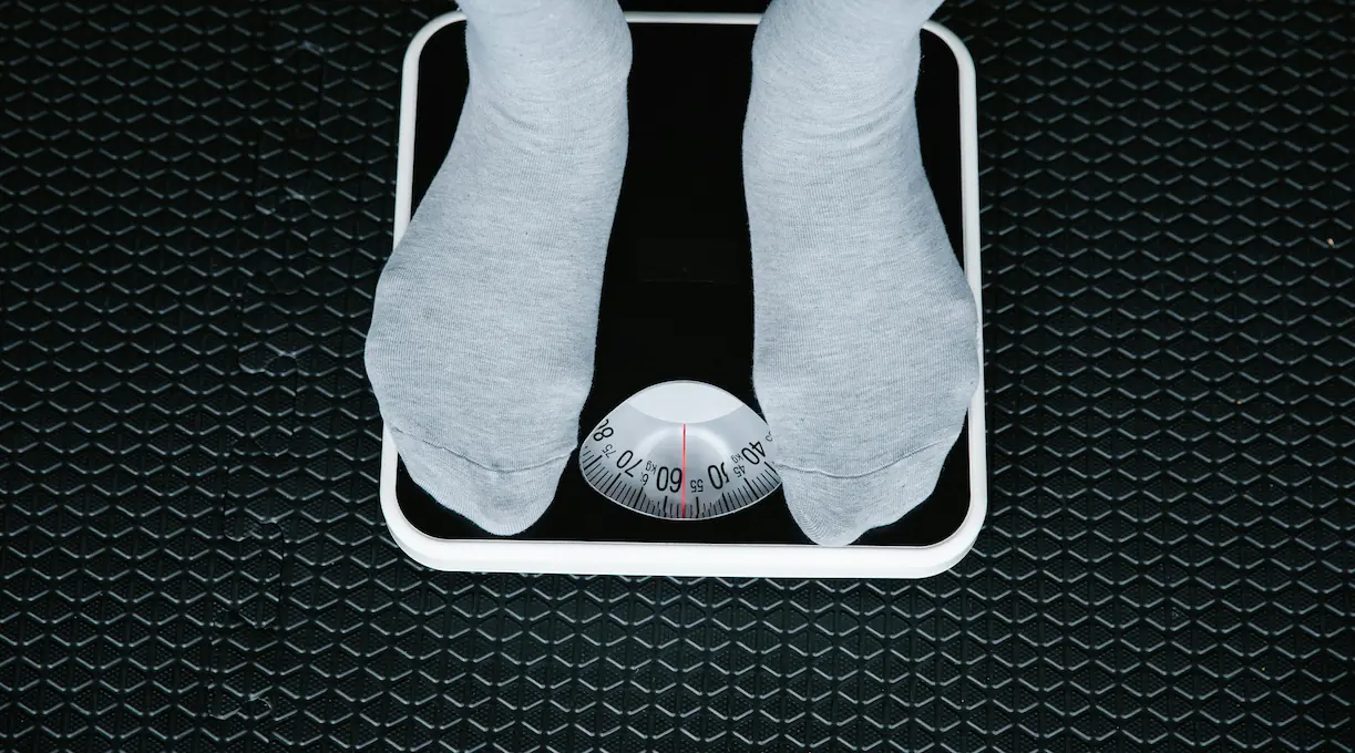person standing on a scale for a blog about how to lose weight